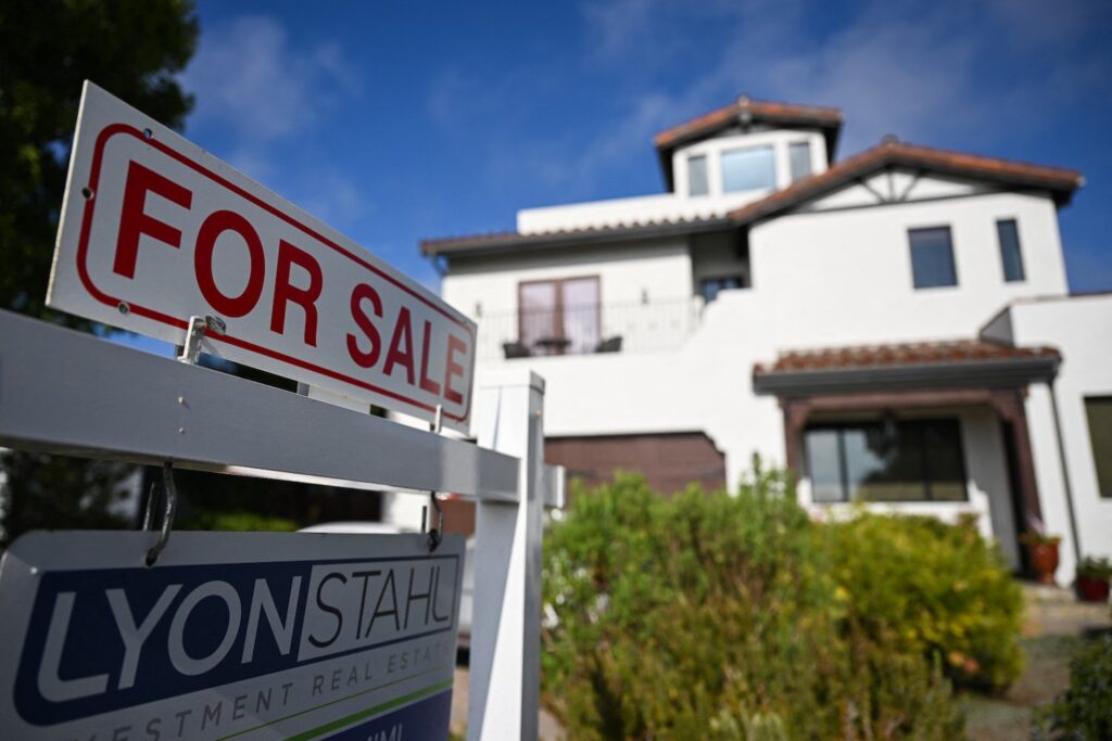 A for sale sign in front of a house