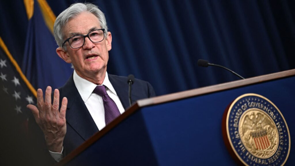 Fed holds rates steady, takes less confident view on inflation