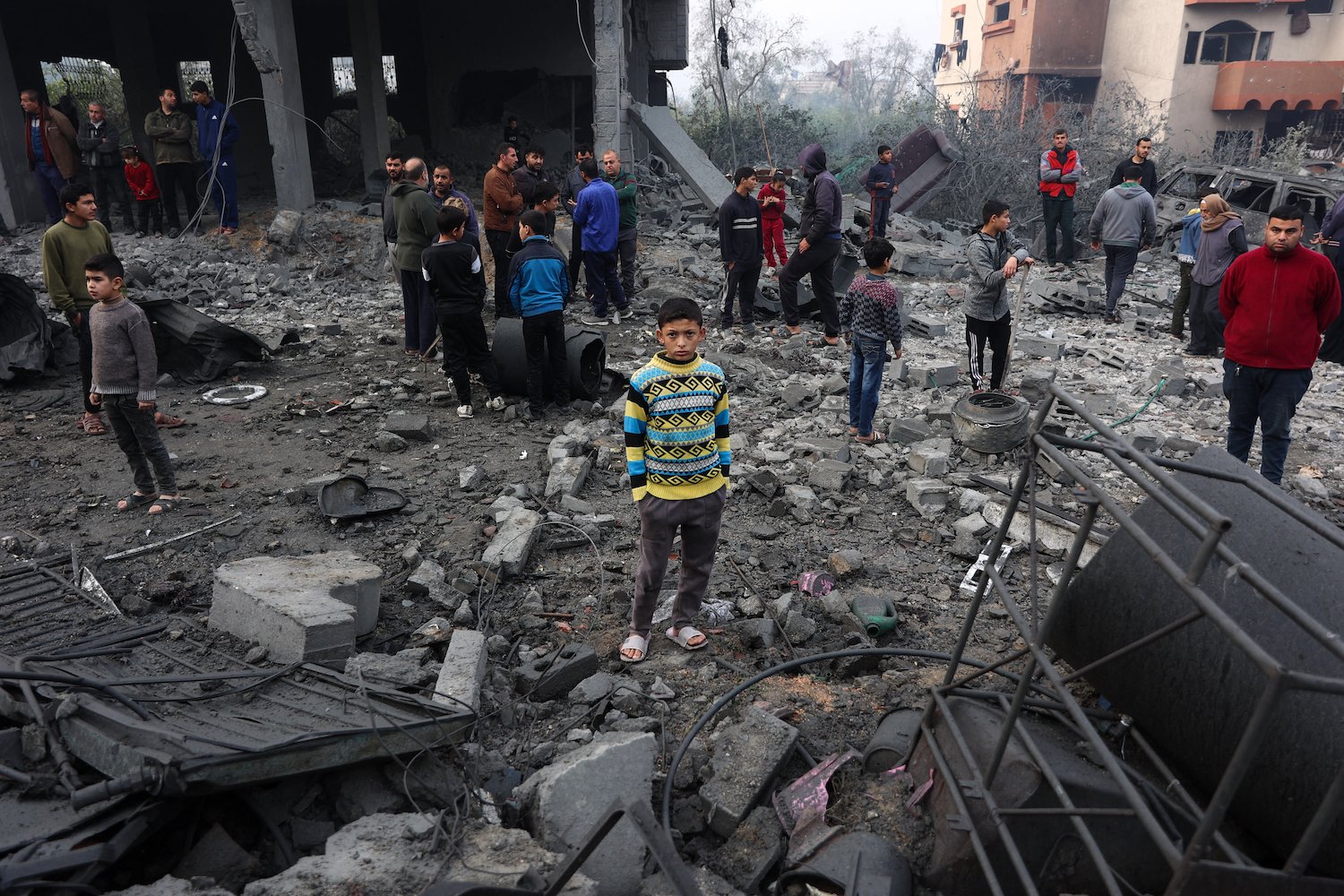 Children stand on a pile of rubble in the northern Gaza Strip