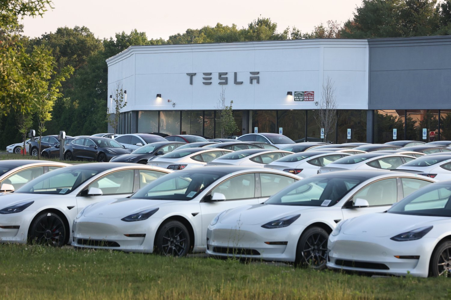 esla electric vehicles fill the car lot at the Tesla retail location