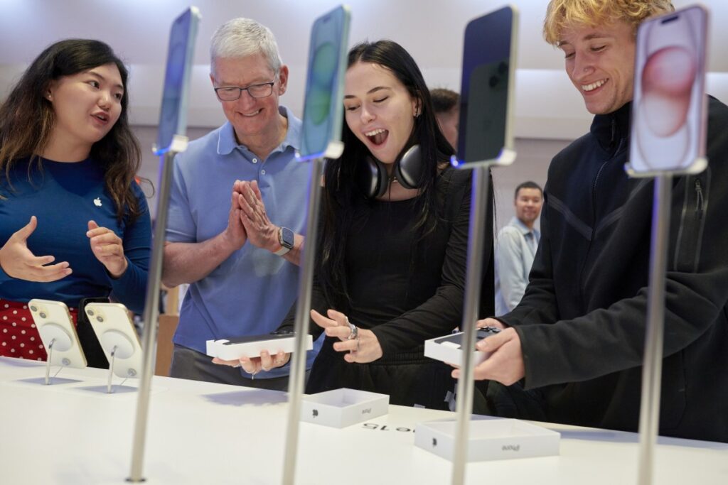 Tim Cook, chief executive officer of Apple Inc., second left, at the company's Fifth Avenue store in New York