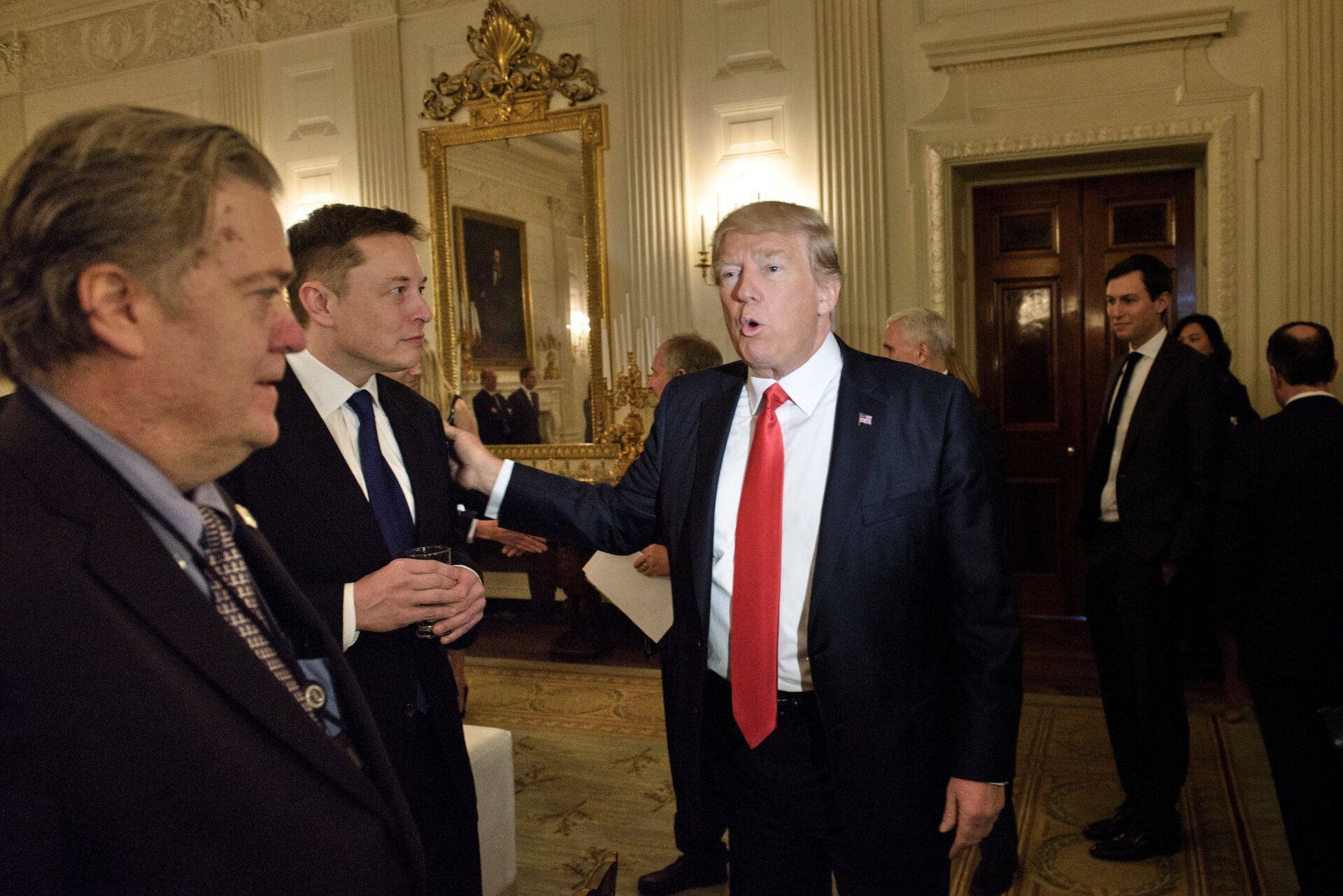 Steve Bannon watches as  President Donald Trump greets Elon Musk