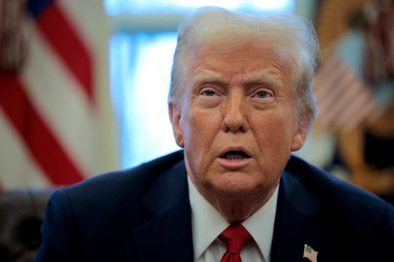 President Donald Trump talks to reporters in the Oval Office at the White House on January 30, 2025 in Washington, DC