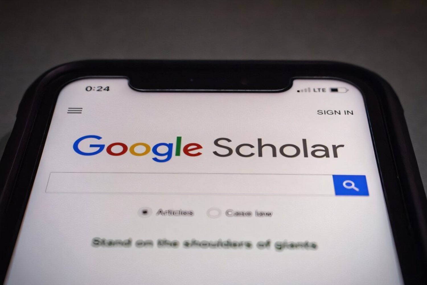 A phone on Google Scholar's landing page.