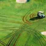 Carl Godfrey illustration of two golfers at the putting green while an electric cart that has left deep wheel marks in the grass sits near a sand bunker