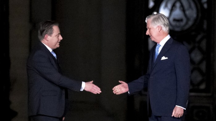 N-VA chair Bart De Wever (left) shakes hands with King Philippe