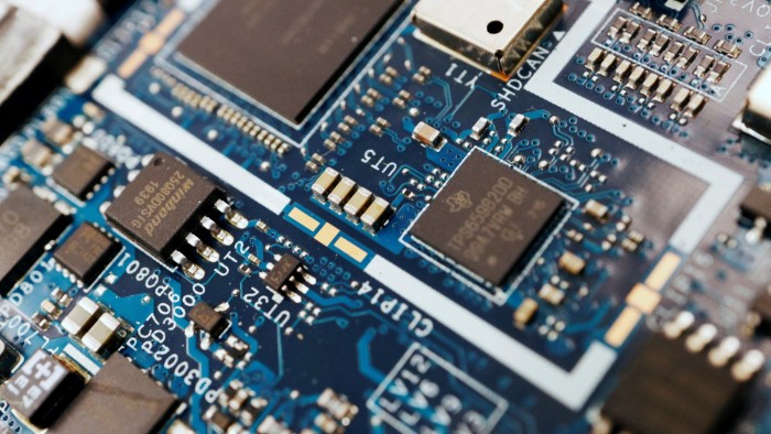 A close-up view of semiconductor chips mounted on a blue computer circuit board