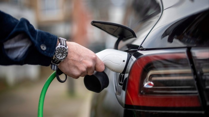 Chris Richmond charges his electric car at home in Bounds Green, North London