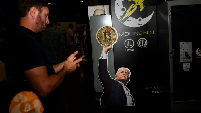 A sign featuring US President Donald Trump on a Moonshot booth during the Bitcoin 2024 conference in Nashville, Tennessee