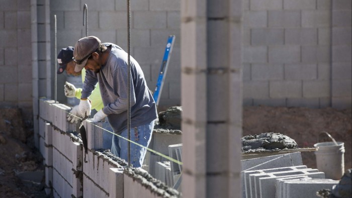 Contractors cement concrete blocks for a home under construction at the DR Horton Express Homes Magma Ranch housing development in Florence, Arizona