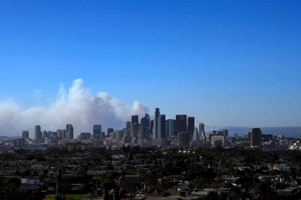 The city skyline is seen as the Palisades Fire burns amid a powerful windstorm on January 7, 2025 in Pacific Palisades, California.