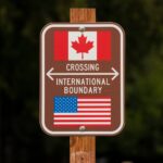 A sign marks the border between the United States and Canada at Peace Arch Park on February 1, 2025 in Blaine, Washington.