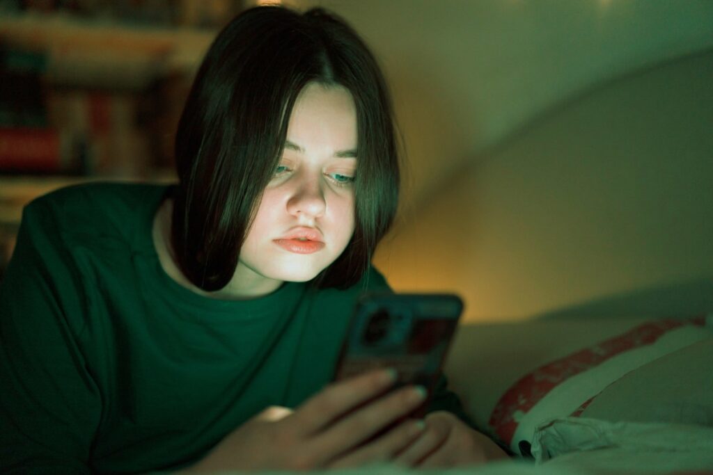 Portrait of a teenage girl looking at her mobile phone.