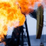 Methane gas flare and pump jack at an oil well in the Bakken Oil Fields, Mountrail County, North Dakota