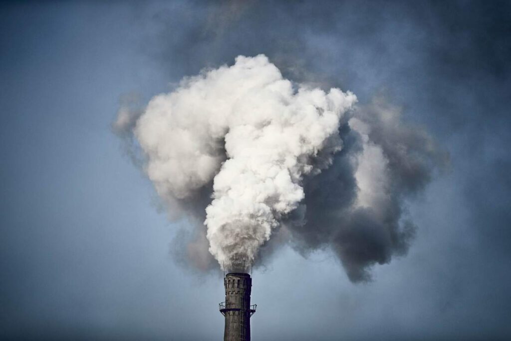 Thick smoke is billowing out of the chimney of a Chinese factory.