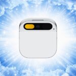 A Humane AI Pin device centered against a background of clouds and shining light beams.