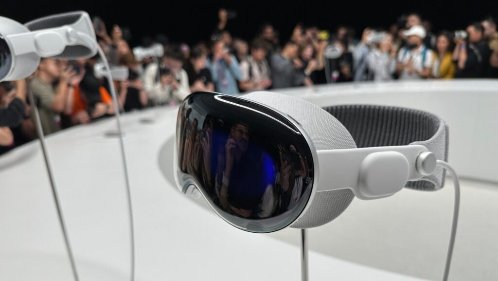 Apple Vision Pro headset on display in front of an audience.