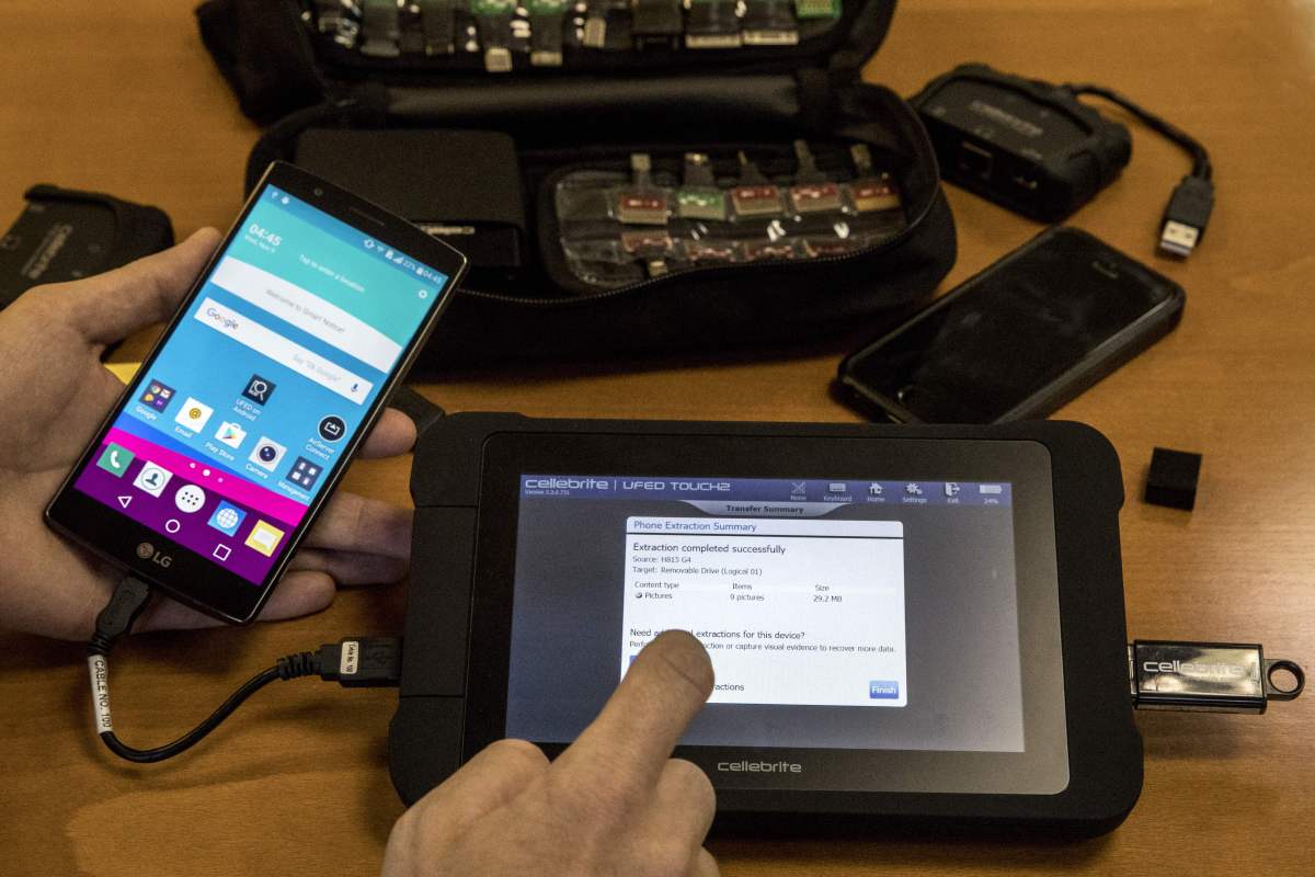 An engineer shows devices and explains the technology developed by the Israeli firm Cellebrite's technology on November 9, 2016 in the Israeli city of Petah Tikva.