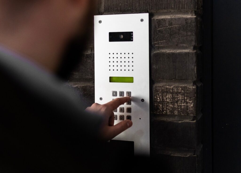 a door entry system on the front of a residential building, illustrated for the story