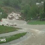 Woman dies in Australian flood as thousands flee homes