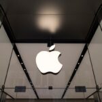 The Apple logo hangs above the entrance to the Apple Shinjuku store