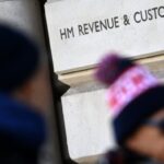 Pedestrians passing the HMRC tax department in London