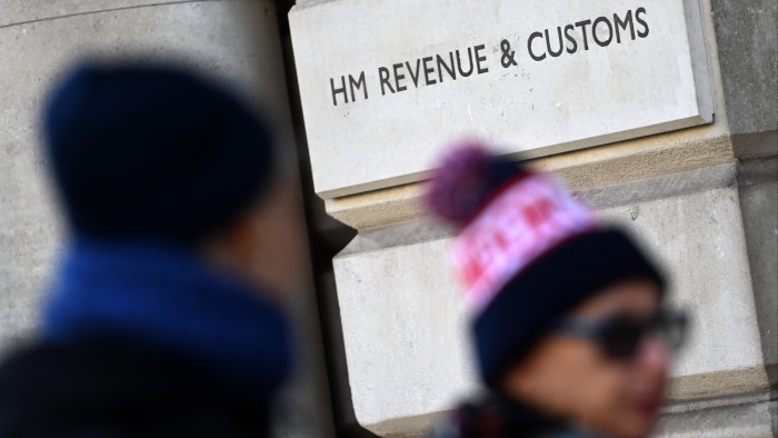 Pedestrians passing the HMRC tax department in London