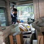 A US Postal Service letter examines a truck full of shipments in Virginia