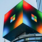 A large Microsoft digital sign displays the company's logo in vibrant colours on the side of a building in New York