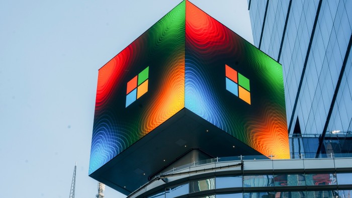 A large Microsoft digital sign displays the company's logo in vibrant colours on the side of a building in New York