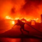 A firefighter battles the Los Angeles wildfires in the Pacific Palisades neighbourhood