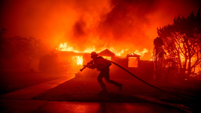 A firefighter battles the Los Angeles wildfires in the Pacific Palisades neighbourhood