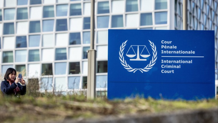 Person outside the hedquarters of the  International Criminal Court