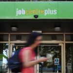 A pedestrian passes a Jobcentre in London