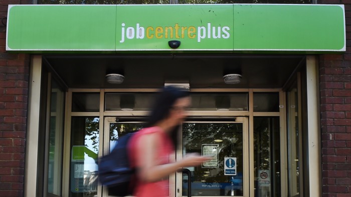 A pedestrian passes a Jobcentre in London