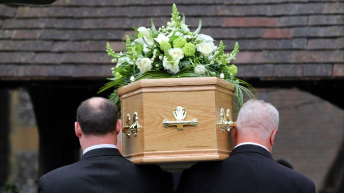 Pallbearers carry a coffin at a funeral