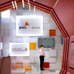 A person stands at a PwC booth at the China International Fair for Trade in Services in Beijing