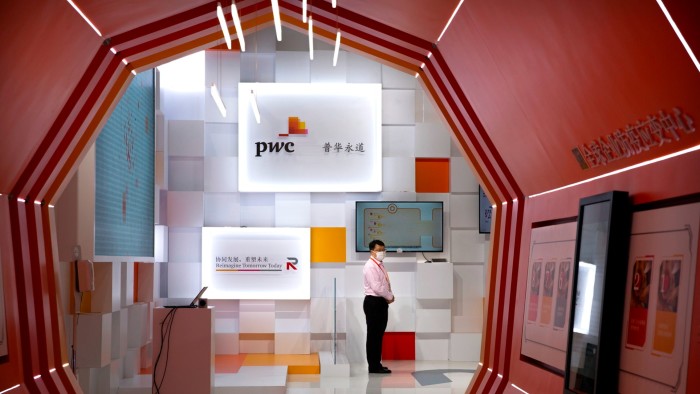 A person stands at a PwC booth at the China International Fair for Trade in Services in Beijing