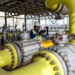 Worker inspects a gas pipe at the Pantano reduction station in Rome, Italy