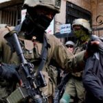 Israeli soldiers detain a youth after preventing access to Palestinians waiting to be let back into the Jenin refugee camp on Wednesday last week