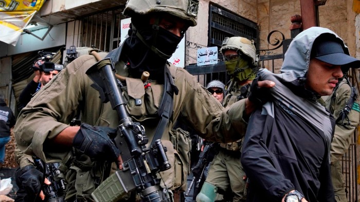 Israeli soldiers detain a youth after preventing access to Palestinians waiting to be let back into the Jenin refugee camp on Wednesday last week