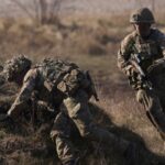 Soldiers storm an enemy position during a simulated attack during Nato military exercises in February 2024 in Poland