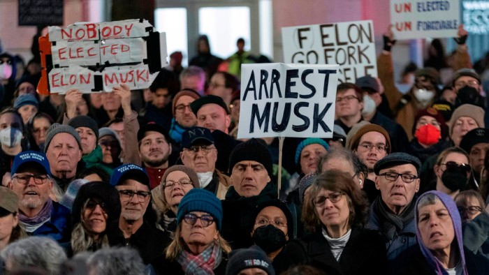 People demonstrate against Elon Musk and his department’s officials outside the US Treasury building in Washington