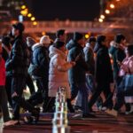 People crossing a Beijing road at night