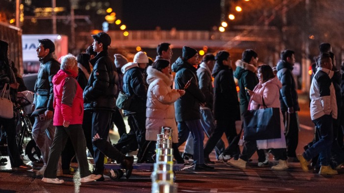 People crossing a Beijing road at night