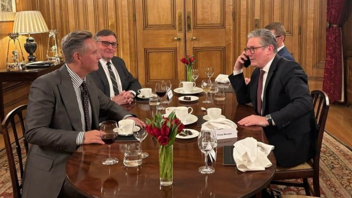 Mark Burnett sits opposite Sir Keir Starmer at a dining table, each with an aide beside them