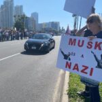 A protester holds a sign that reads "Musk is a Nazi" at a protest on Feb. 17, 2025 in San Diego, California.