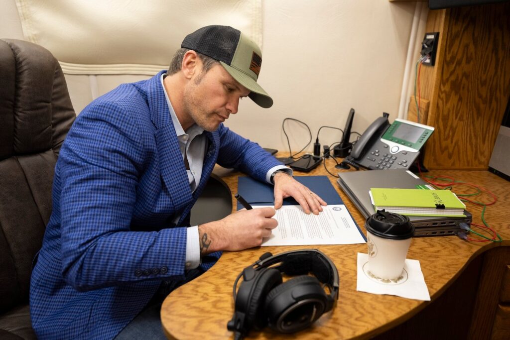 Secretary of Defense Pete Hegseth signs a memorandum reversing the name of Fort Liberty back to Fort Bragg while flying in a C-17 operated by the 300th Airlift Squadron en route to Stuttgart, Germany, Feb. 10, 2025