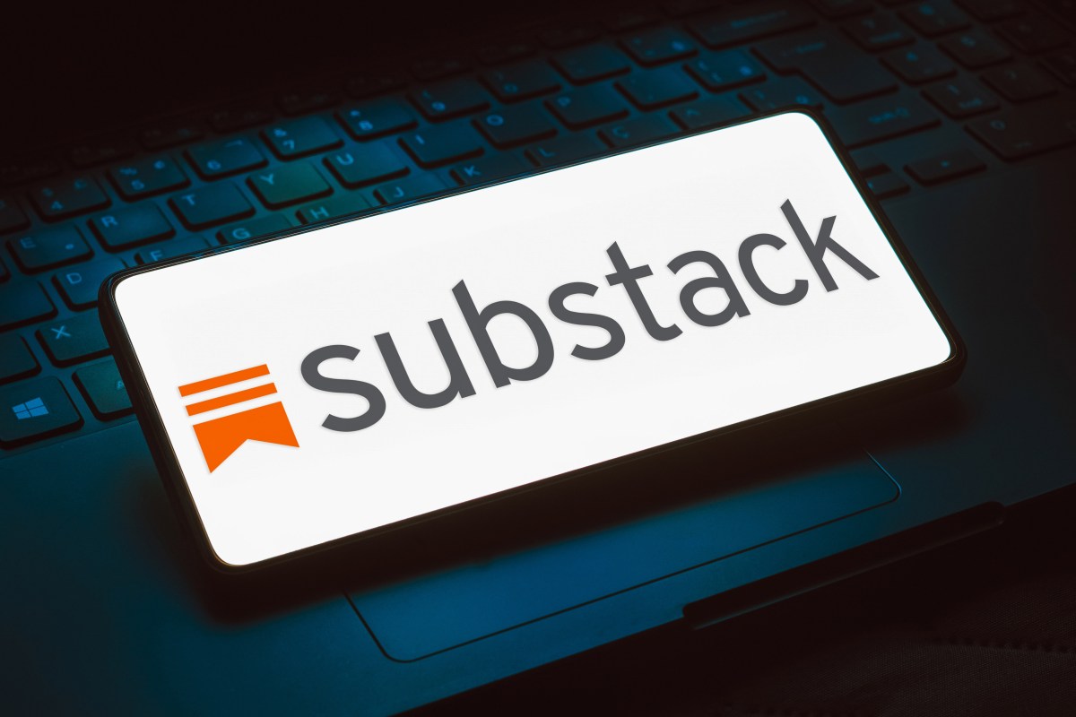 The Substack logo displayed on a phone that is resting on top of a keyboard