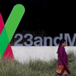 A pedestrian walks by a sign posted in front of the 23andMe headquarters in Sunnyvale, California. (Image: Justin Sullivan/Getty Images)